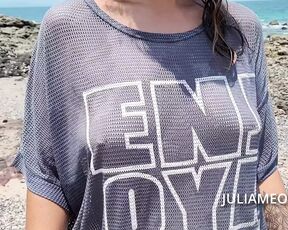 Hot mom in transparent t-shirt on the beach at low tide